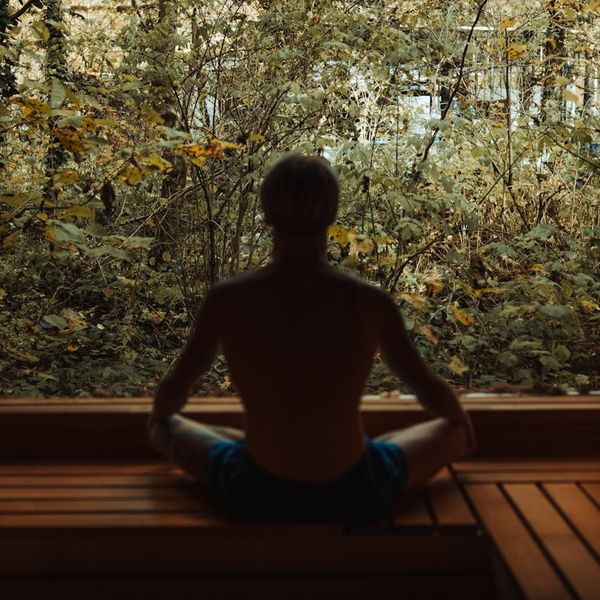 Silhouette of a man meditating, showing balance and mental clarity.